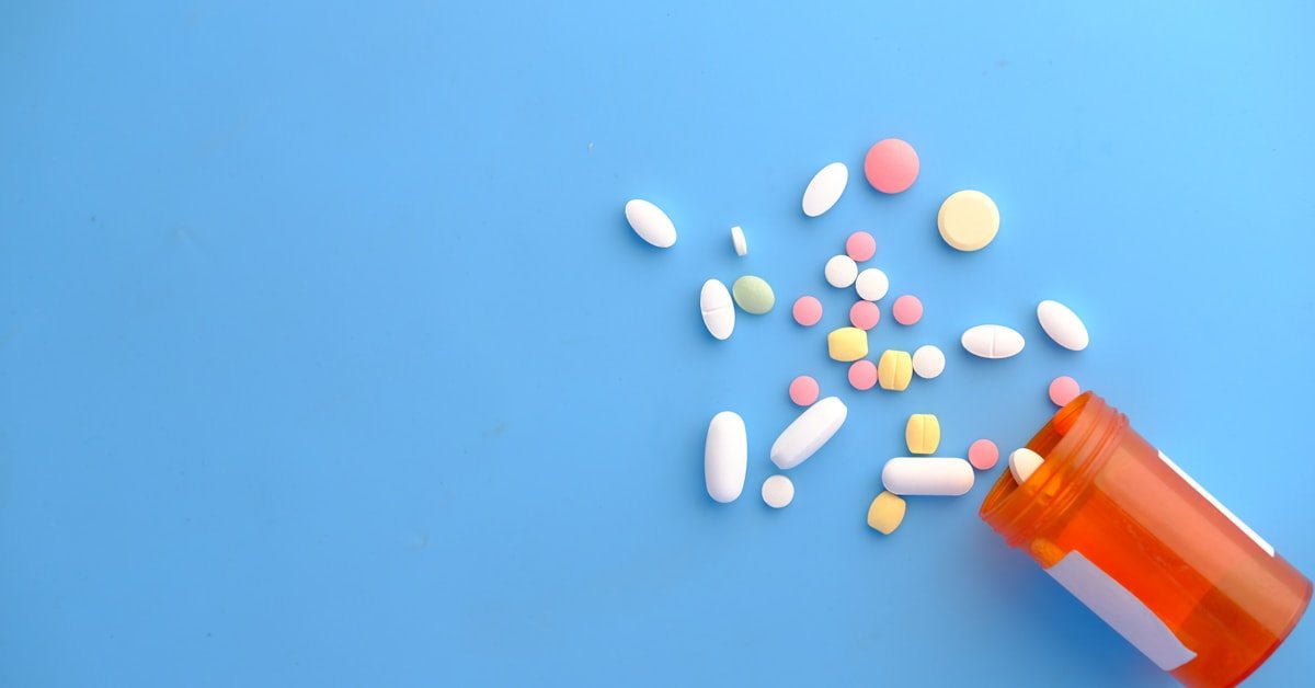 Colorful pills from orange bottle
