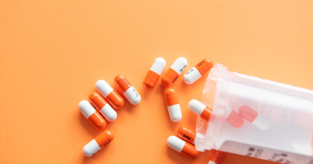 Orange and white medication pills