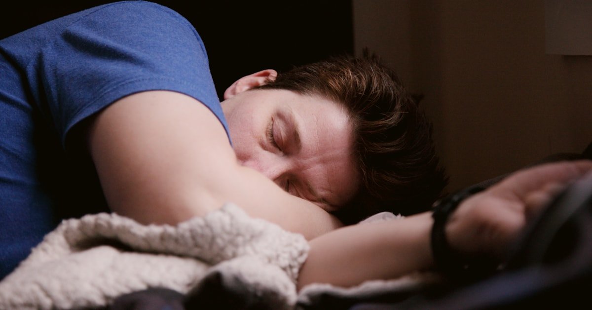 Man in blue shirt sleeping