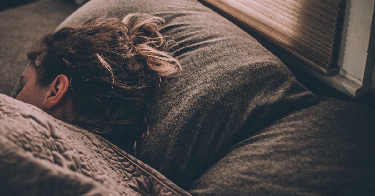 Woman sleeping under blankets